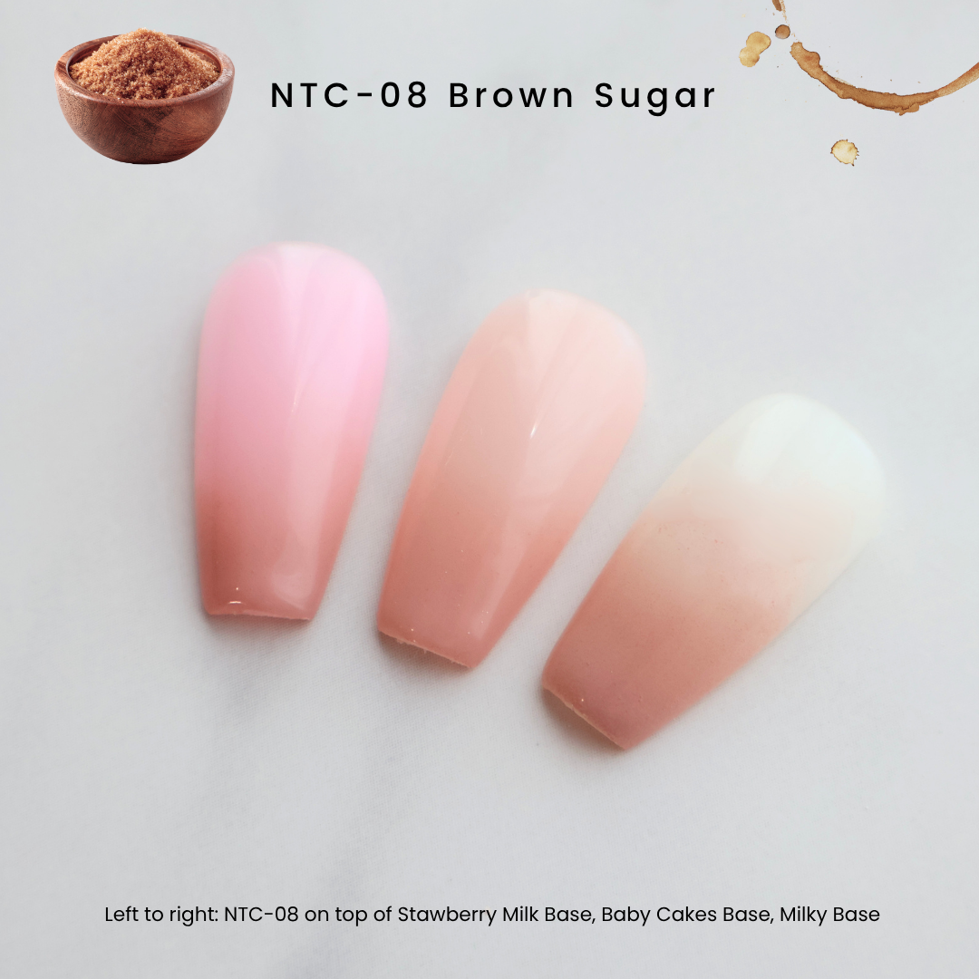 Three false nail tips with pink ombré gradients in shades of light pink, peach, and milky white, labeled as NTC-08 Brown Sugar. A small bowl of brown powder and a coffee splash are shown in the top corners, with text indicating the layers: Strawberry Milk Base, Baby Cakes Base, and Milky Base.